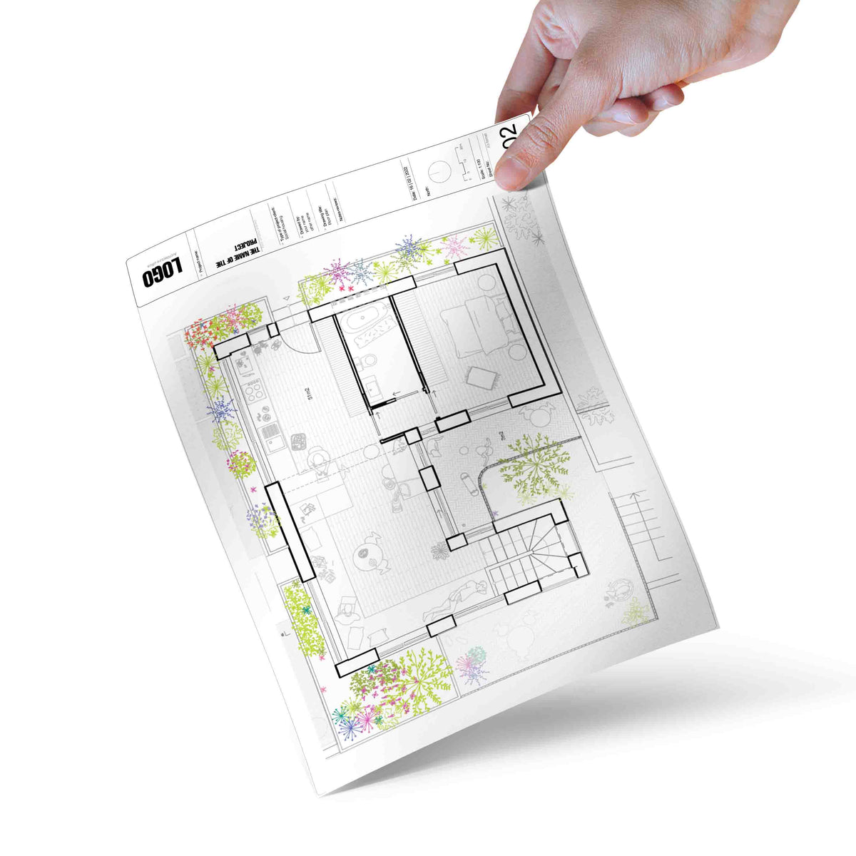 Hand holding a printed floor plan sheet with coloured trees and shrubs in plan placed around a house
